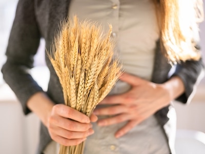 A woman holding dried wheat.