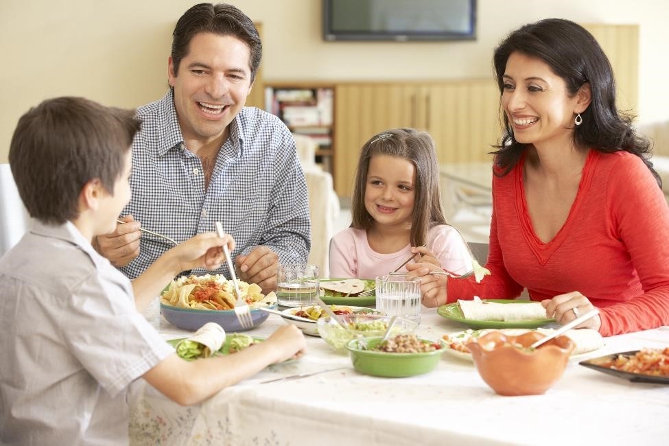 Family of four eating dinner.