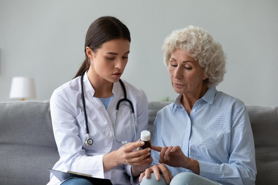 Health care professional talking with a patient about a medicine.