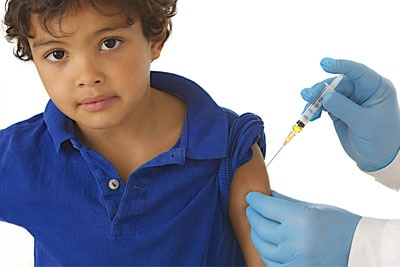 Doctor giving a vaccine shot to a small child.