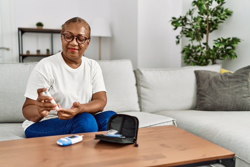 A woman checking her blood glucose level with a blood glucose meter
