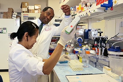 Photo of Dr. Griffin Rodgers in a lab 