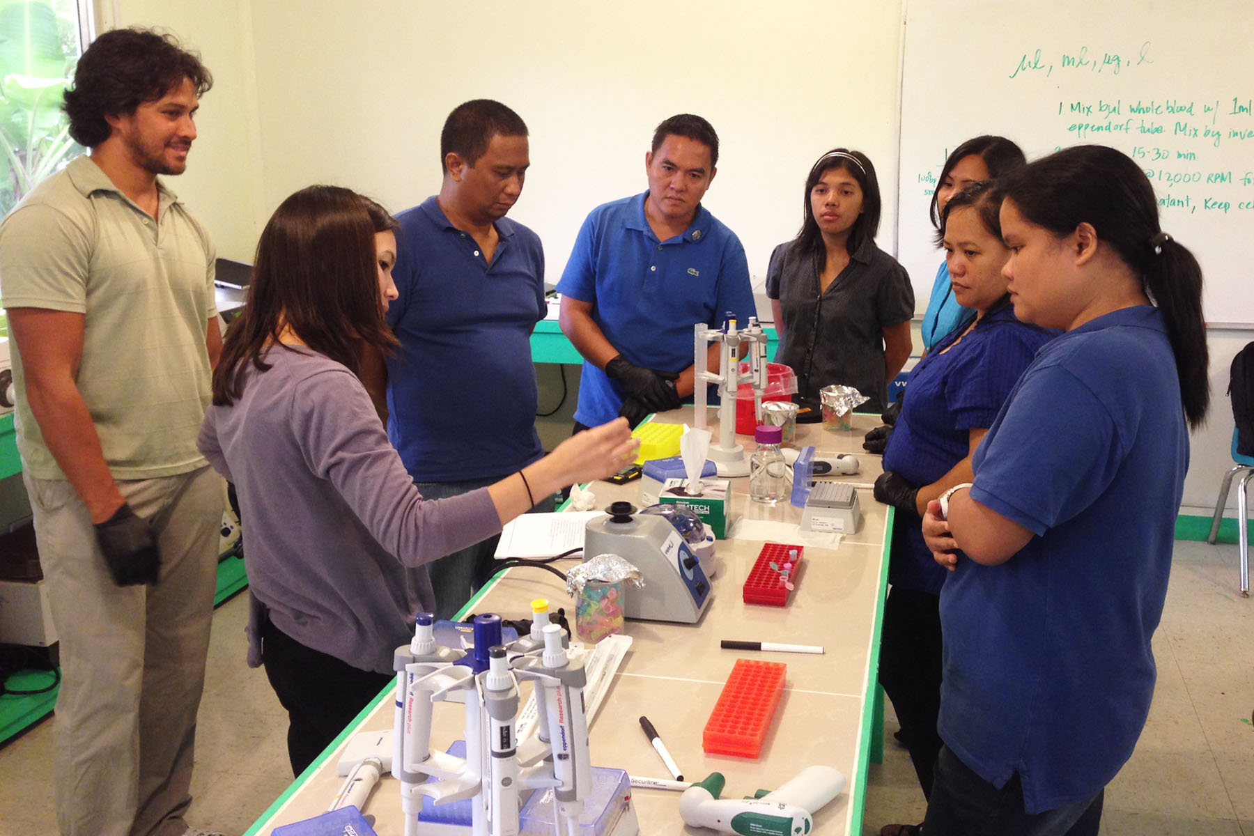 Photo of teachers helping STEP-UP students at the Pacific molecular biology laboratory in Palau.