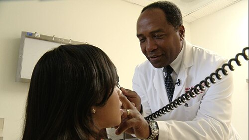 Photo of Dr. Rodgers examining a patient