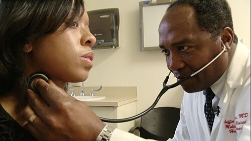 Photo of Dr. Rodgers examining a patient