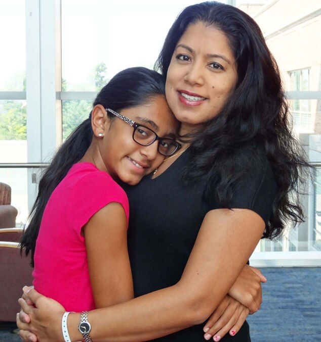 Photo of Radhika Sawh holding her daughter