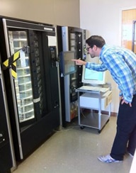 Photo of a man using a vending machine