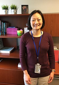 Photo of Dr. Jessica Lee standing at desk