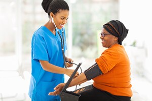 Photo of health practitioner performing blood pressure test on patient