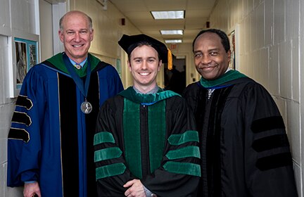 Photo of Dr. Griffin P. Rodgers (on the right side) and Dr. Jeffrey Akman (on the left side), dean of George Washington University’s School of Medicine and Health Sciences, standing with a graduate (in the center) who donated a kidney after taking an anatomy class. 
