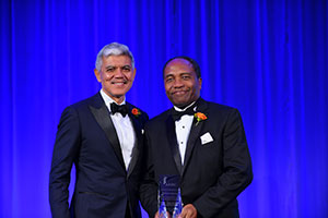 Photo of Dr. Rodgers holding the Nickens Award