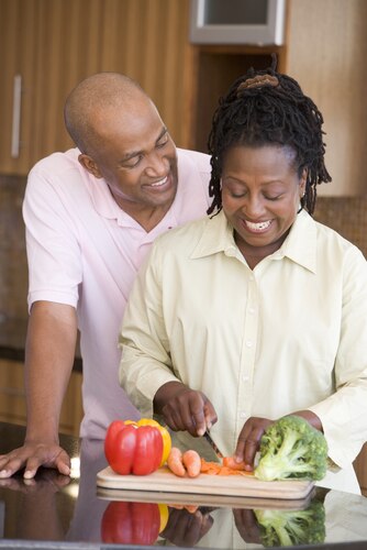A husband and wife preparing a meal together