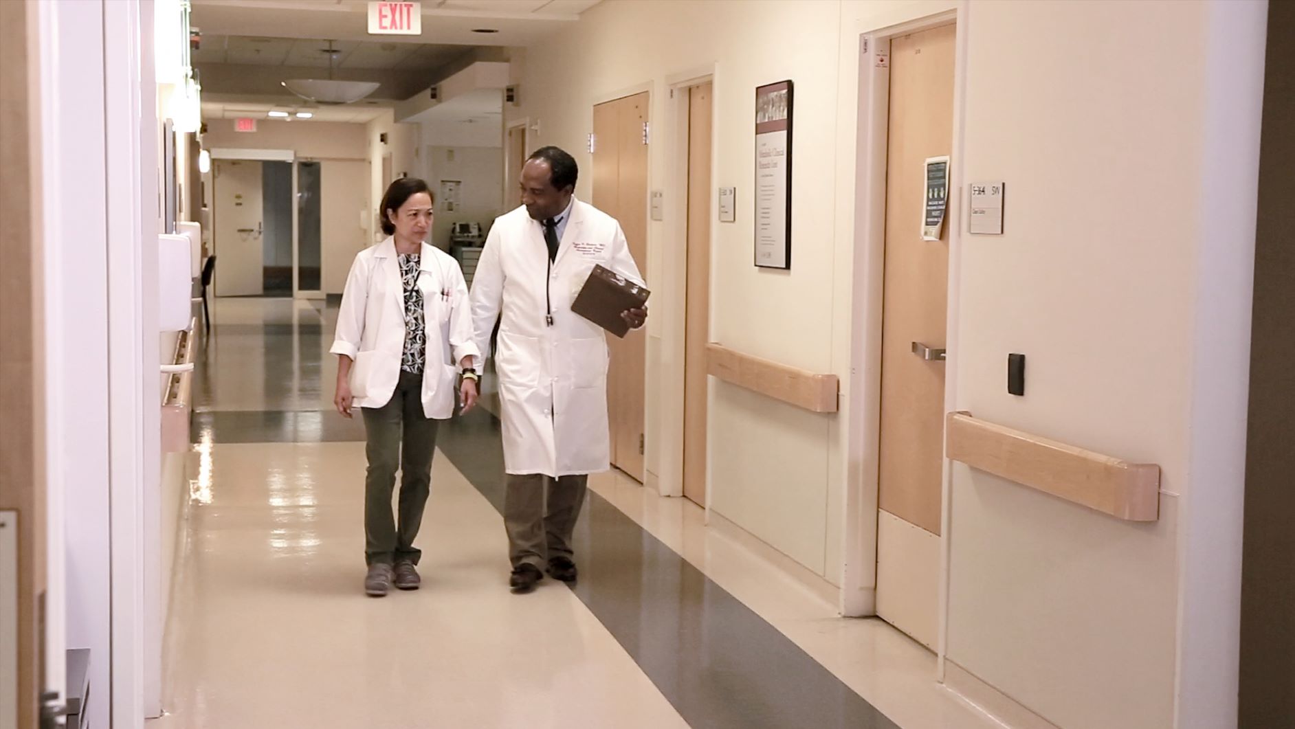 Dr. Rodgers walking through a hallway talking with another doctor.