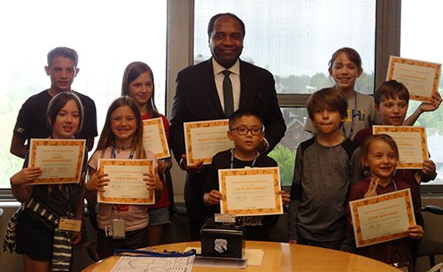 Photo of Dr. Griffin P. Rodgers with a group of children