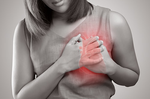 Photo of a woman with her hands placed on her heart
