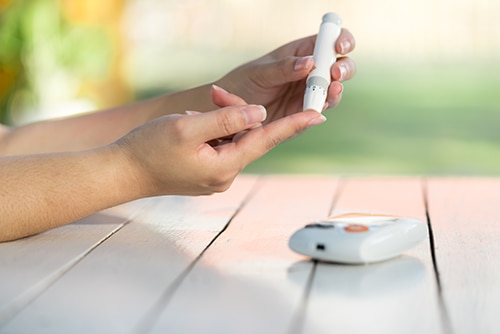 Photo of a person testing their blood glucose