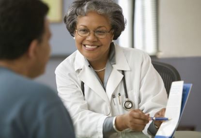 Female doctor going over a form with a patient.