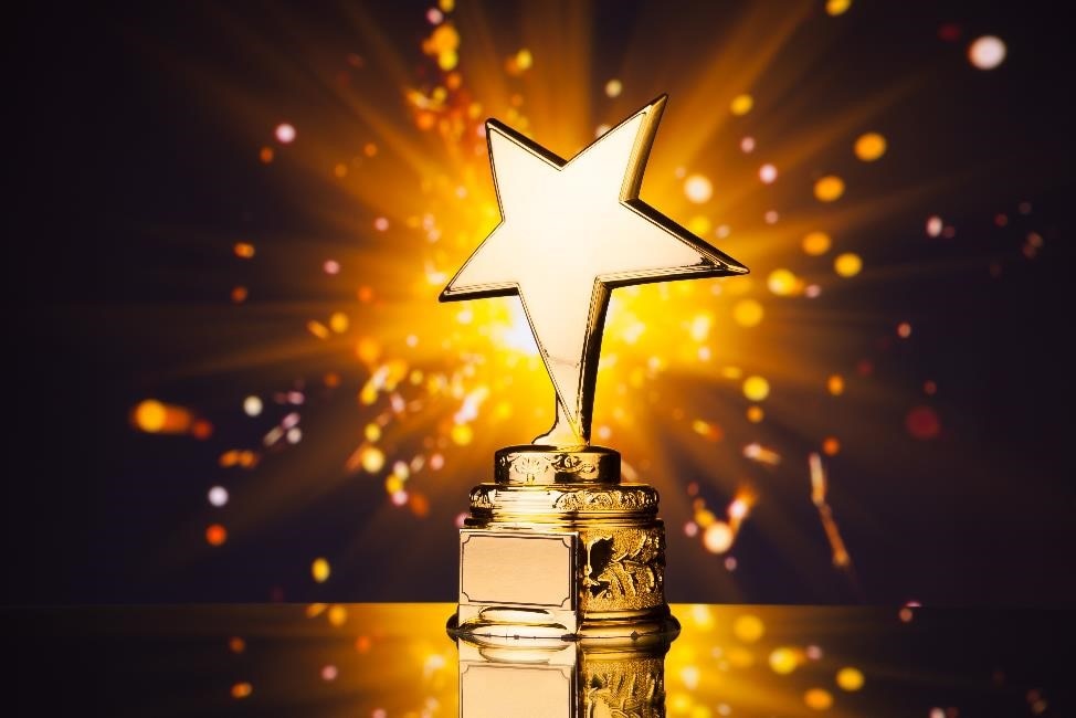 Gold star trophy with sparks flying behind it.