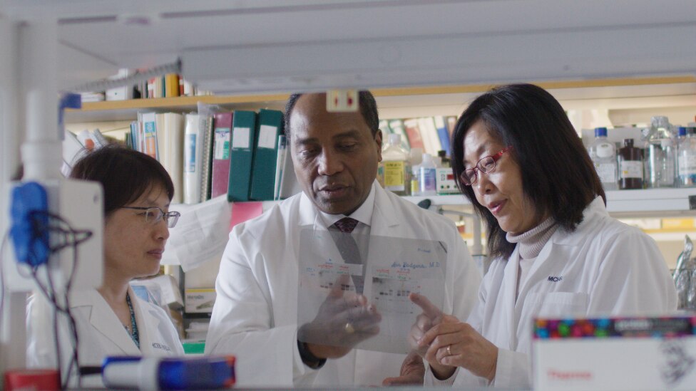 Dr. Rodgers looking at results with two other researchers.