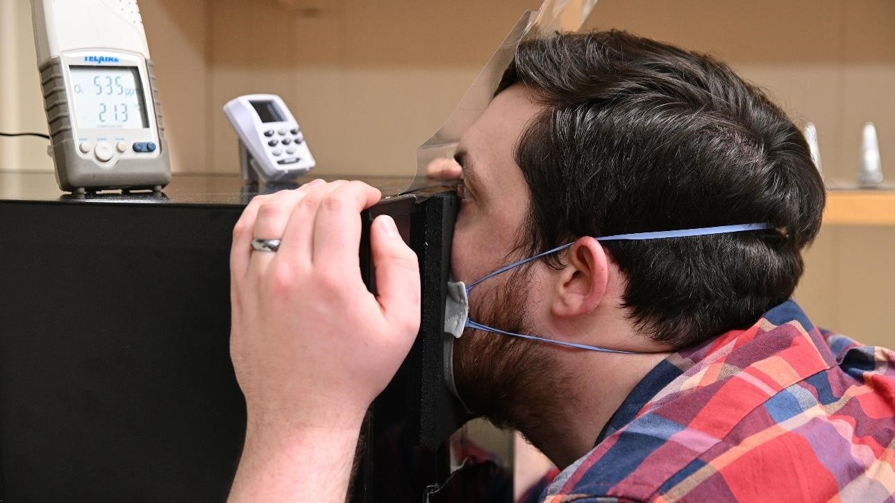 Study volunteer breathes into box to measure humidity