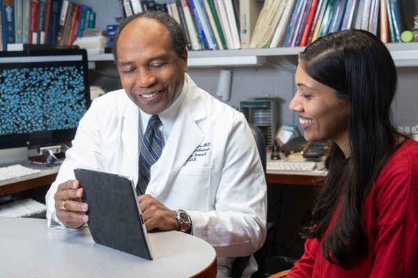 Dr. Rodgers Speaking with a PI using a Tablet