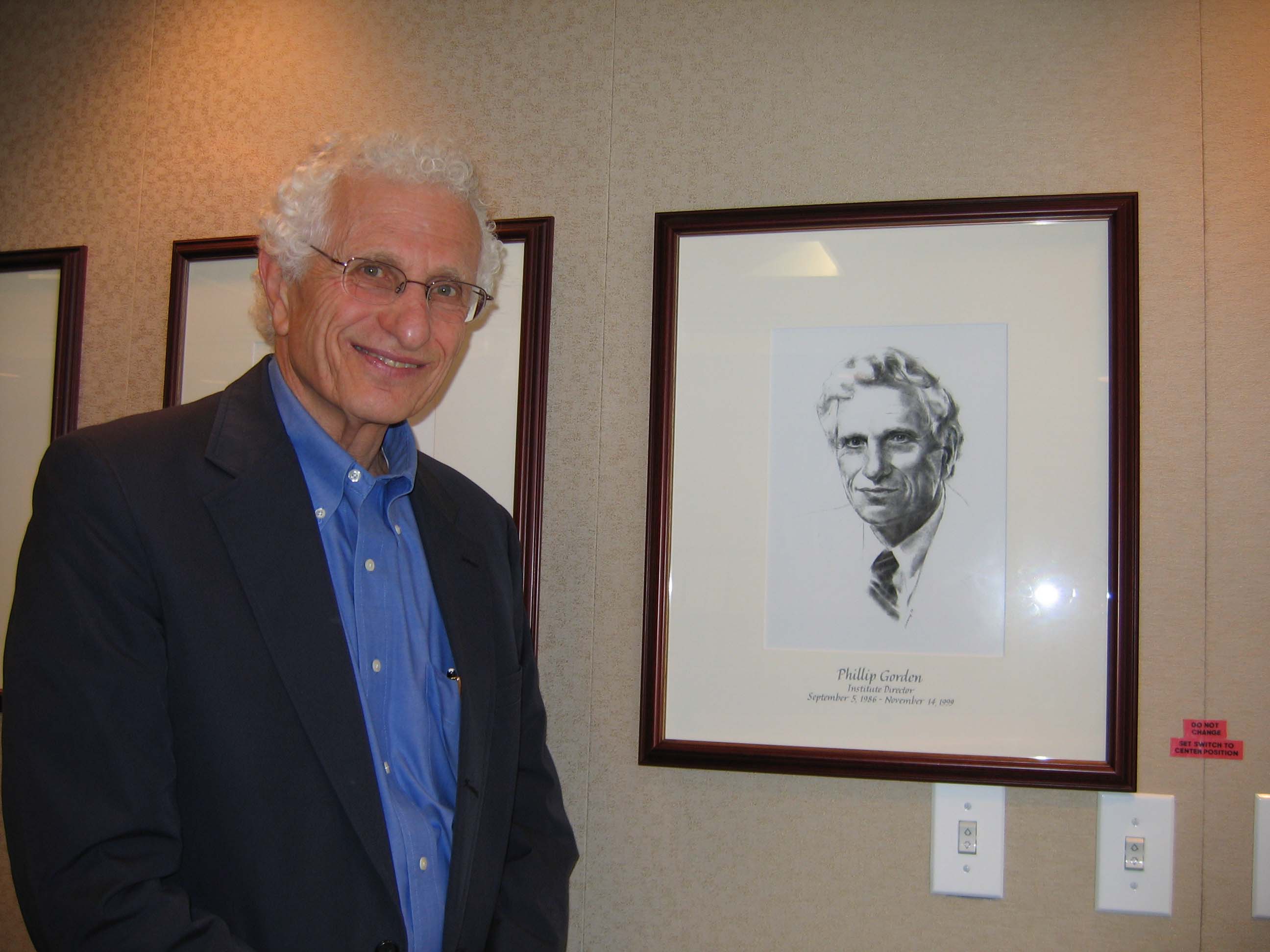Phillip Gorden stands with his director’s portrait