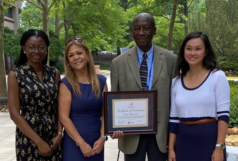 Four NIDDK staff standing together and smiling at retirement event