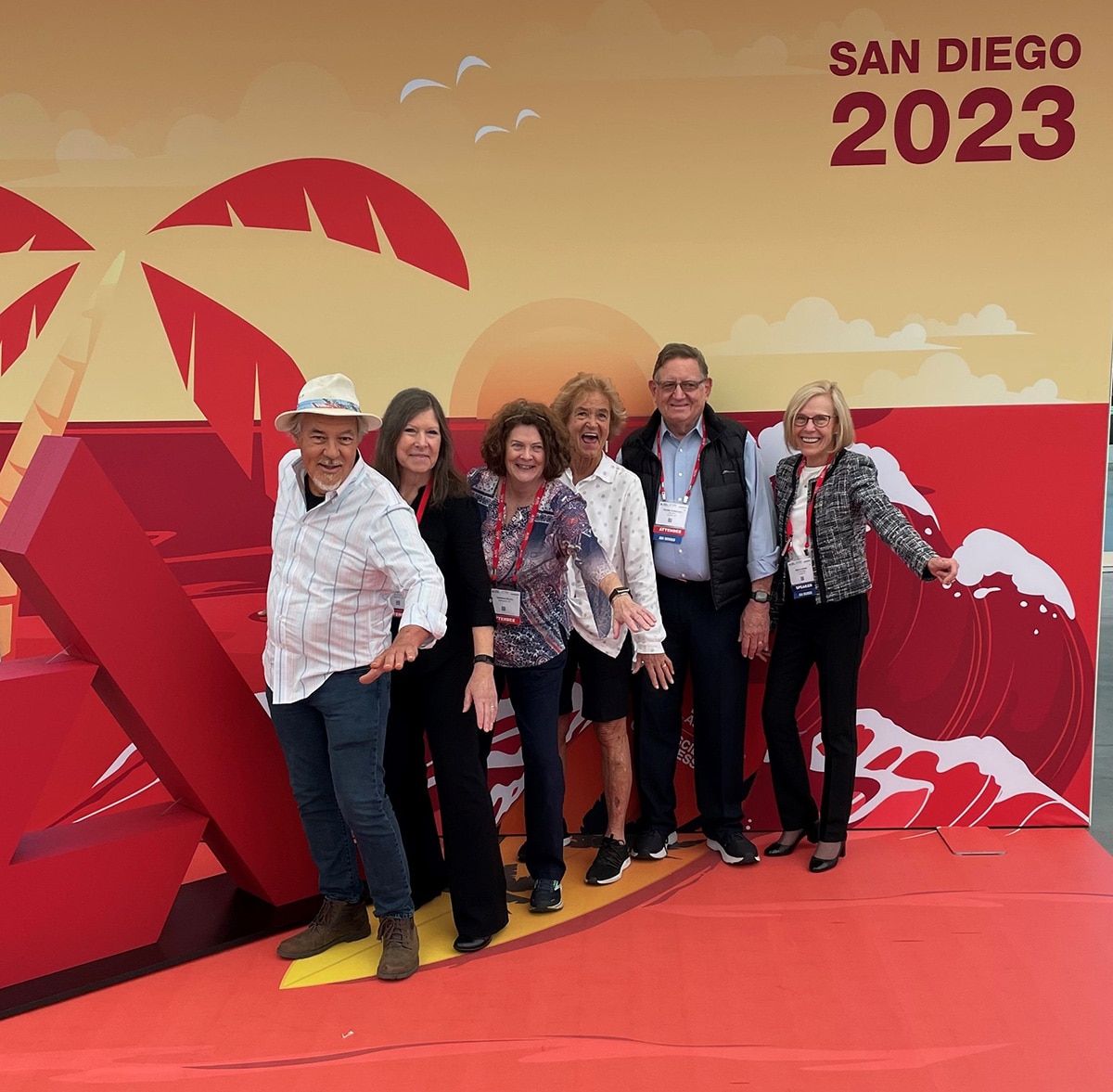 DCCT/EDIC study participants and staff from UC San Diego posing in front of a beach background illustration