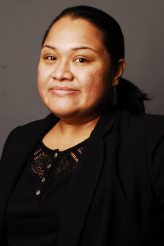 Female with brown hair smiling and wearing a black shirt.