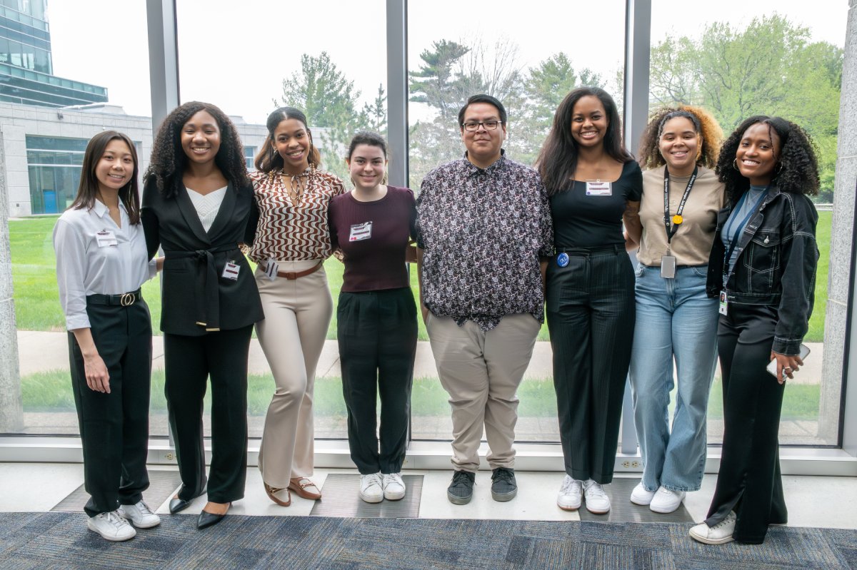 2023 DPSP Cohort members standing in front of a window.
