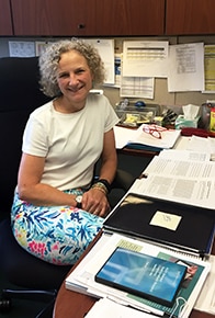 Photo of Dr. Tracy Rankin sitting at desk