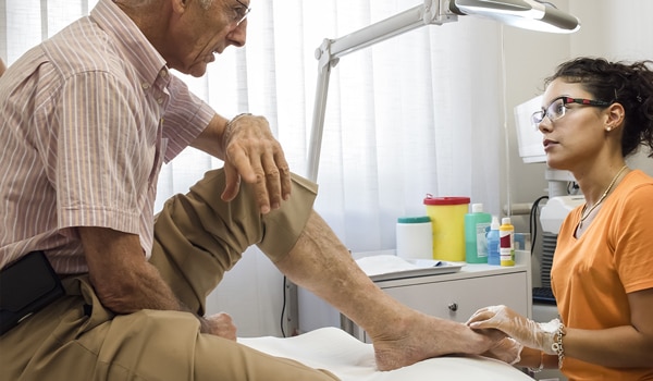 A doctor examining a patient's foot