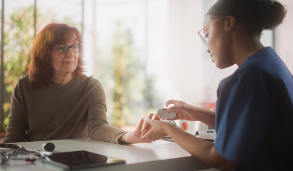 A health care professional taking a blood sample from a patient.