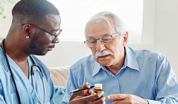 A health care professional and patient discussing medication.