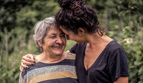 A young woman hugging her grandmother