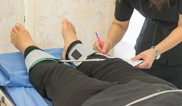 A doctor examining a persons foot