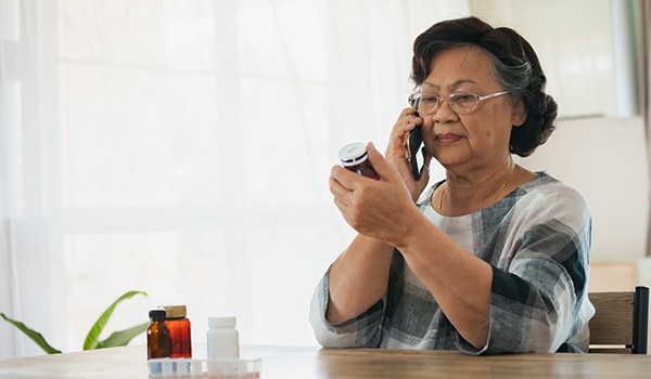 Woman Looking at Prescription Bottle