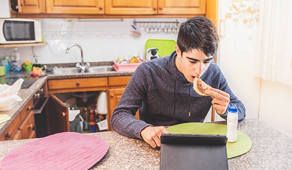 A teen eating a sandwich.