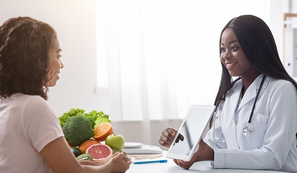 Doctor sharing information with a patient on a tablet