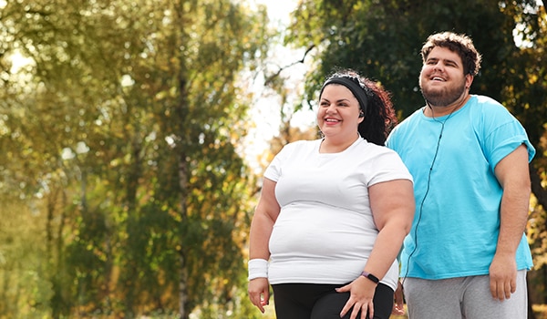 Two people walking outside