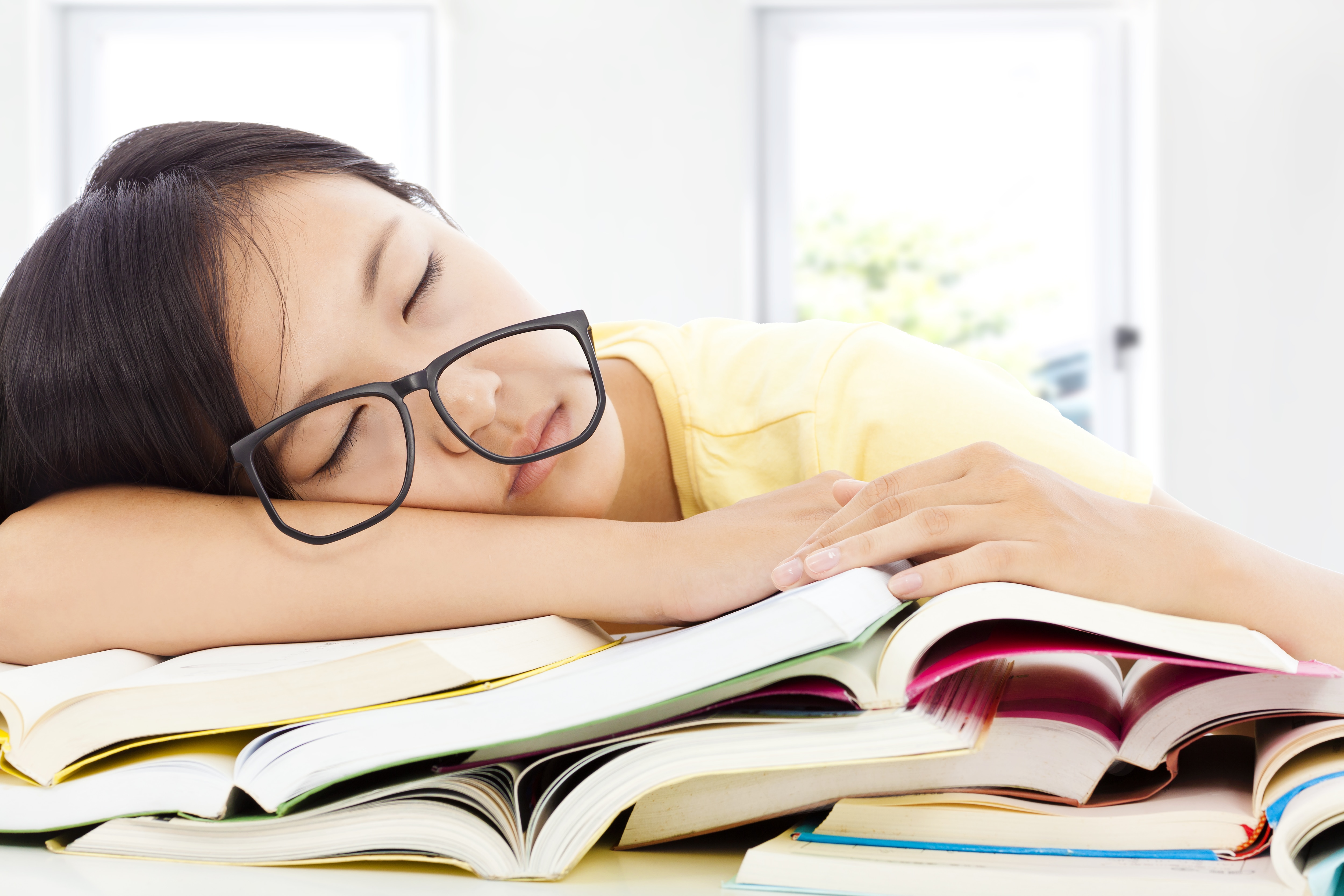 Child sleeping on books