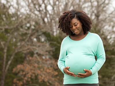A pregnant woman outdoors.