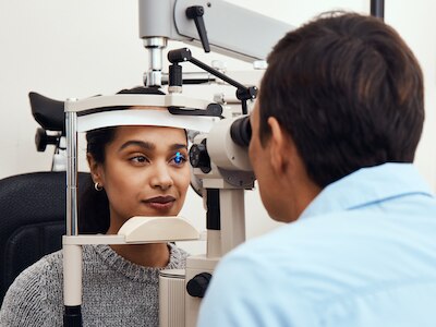A patient at an eye exam with a doctor.