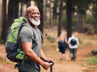 A senior man hiking in a forest.
