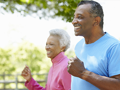 A man and woman outdoors walking.
