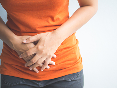 A woman holding her stomach.