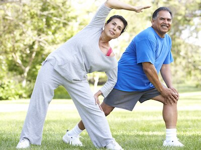 Two people stretching for exercise.