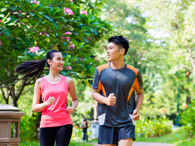 Two people jogging outside.
