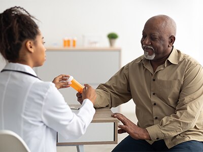 A patient talking with a health care provider about medication.