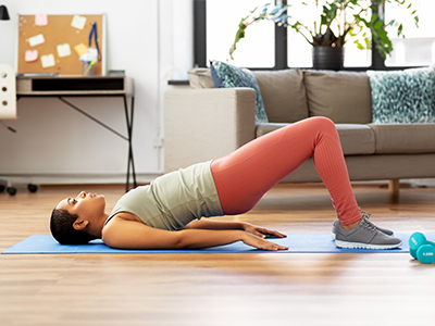 Person doing pelvic lift abdominal exercise at home.